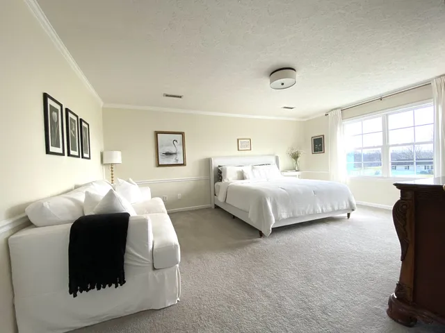 a bedroom with a bed gym equipment and a window