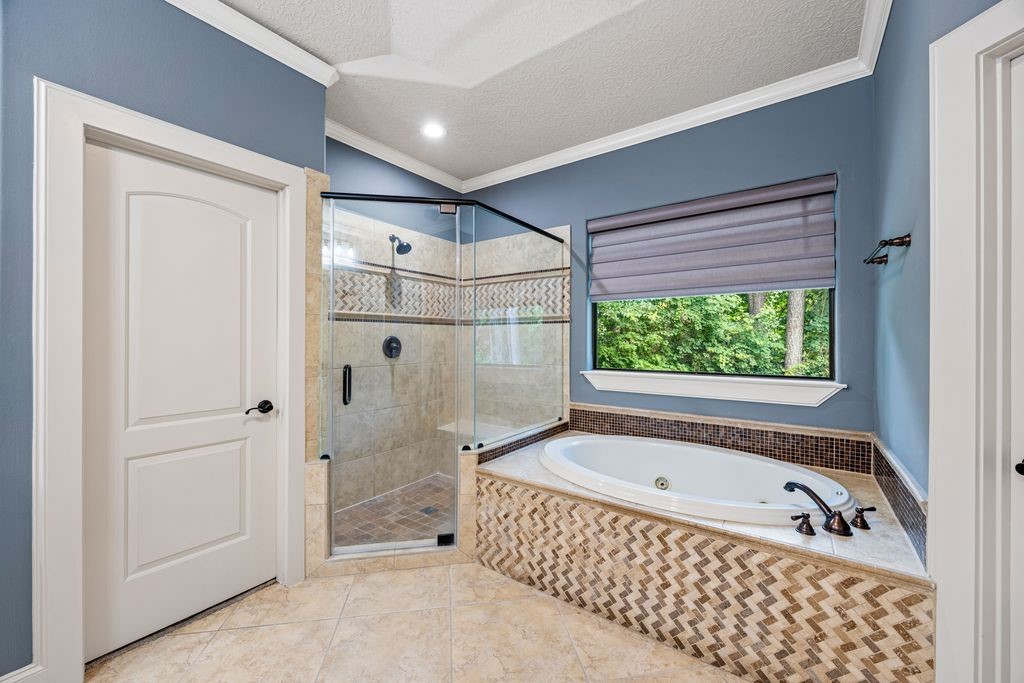 27722 Tiverton Court Spring, TX 77386 - Photo 15 of 33 Luxury Spa Experience at Home!
The lavish primary bath is designed as a personal wellness retreat, featuring a soaking tub, spacious walk-in shower, and a spa-inspired layout that encourages complete relaxation. A bespoke furniture-quality vanity serves as both a stunning focal point and a practical workspace, complete with an integrated illuminated makeup station thoughtfully crafted for everyday convenience.