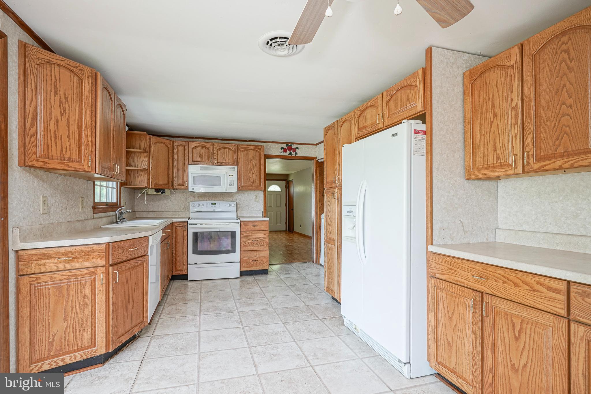 69 Buckhorn Road Salem, NJ 08079 - Photo 15 of 38 a large kitchen with stainless steel appliances lots of white cabinets