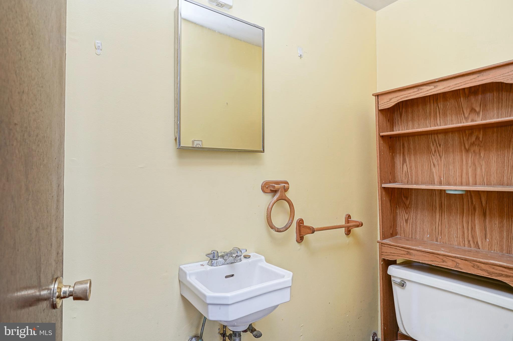 69 Buckhorn Road Salem, NJ 08079 - Photo 23 of 38 a bathroom with a sink a toilet and a mirror