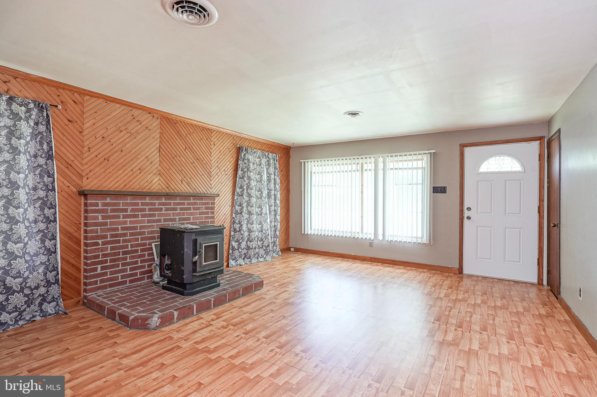69 Buckhorn Road Salem, NJ 08079 - Photo 9 of 38 a view of empty room with wooden floor and fireplace