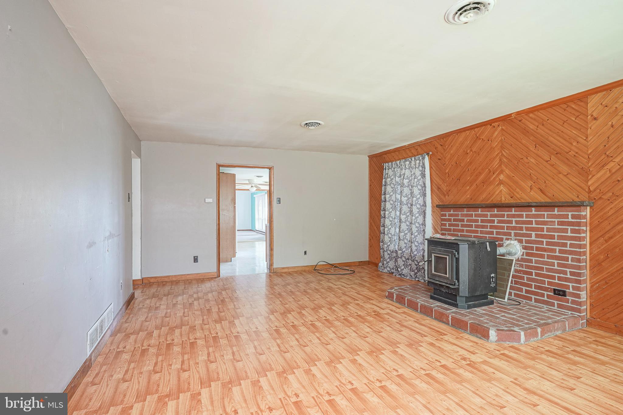 69 Buckhorn Road Salem, NJ 08079 - Photo 10 of 38 a view of an empty room with wooden floor and a window