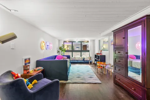 a living room with furniture and a floor to ceiling window