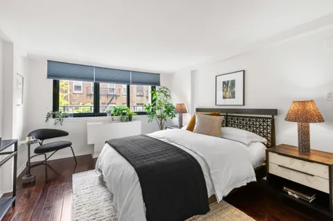 a bedroom with bed and a window