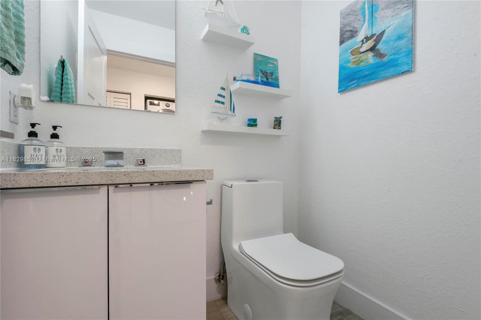 325 Calusa Street Key Largo, FL 33037 - Photo 13 of 17 a bathroom with a toilet sink and mirror