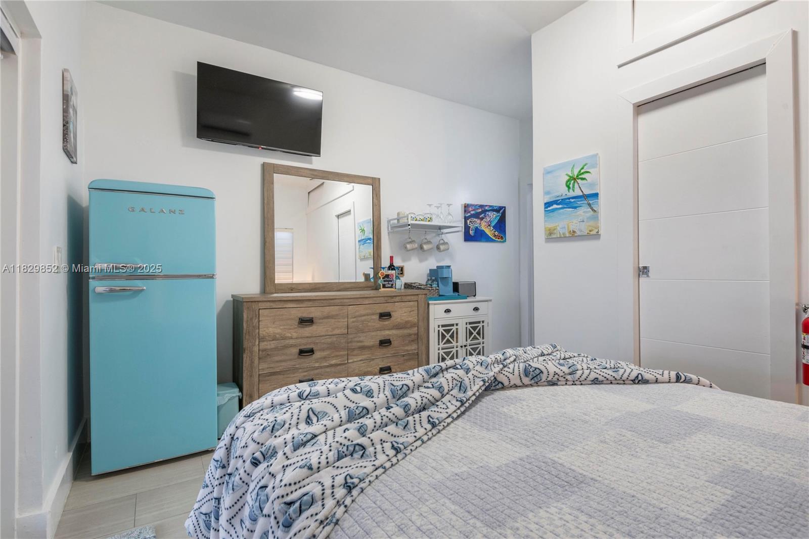 325 Calusa Street Key Largo, FL 33037 - Photo 15 of 17 a bedroom with a bed and flat screen tv