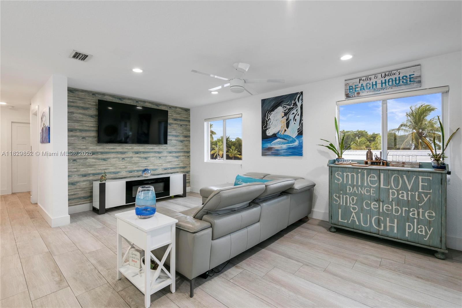 325 Calusa Street Key Largo, FL 33037 - Photo 2 of 17 a living room with furniture a flat screen tv and a fireplace