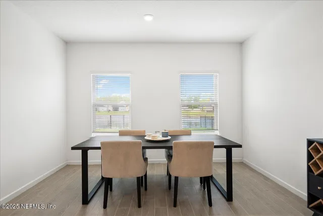 a view of a dining room with furniture and window