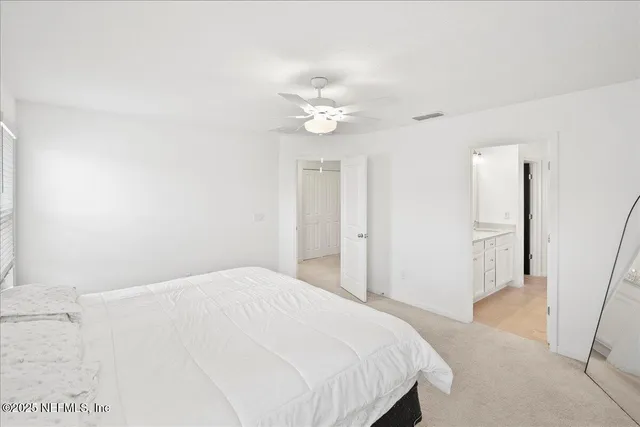 a bedroom with a bed and a ceiling fan