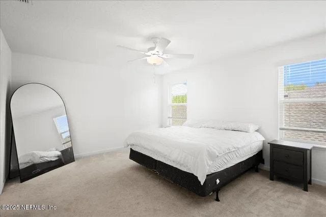 a bed sitting in a bedroom next to a window