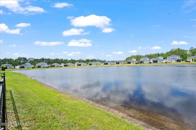 a view of a lake with houses in the back