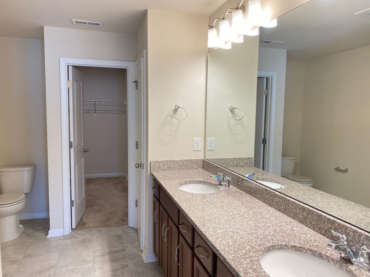 1005 Saffron Loop Durham, NC 27713 - Photo 11 of 26 a bathroom with a granite countertop sink and a mirror