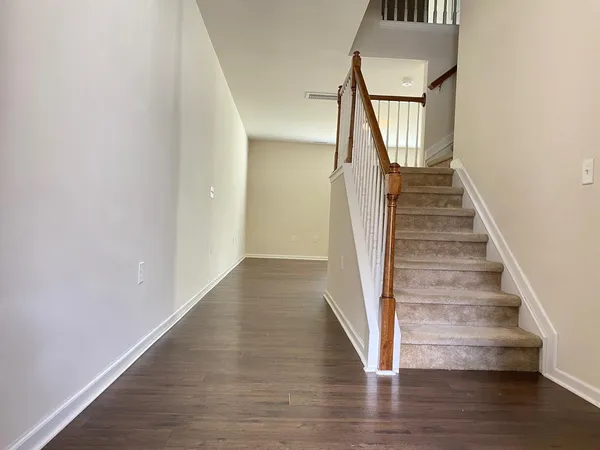 a view of entryway and hall with wooden floor