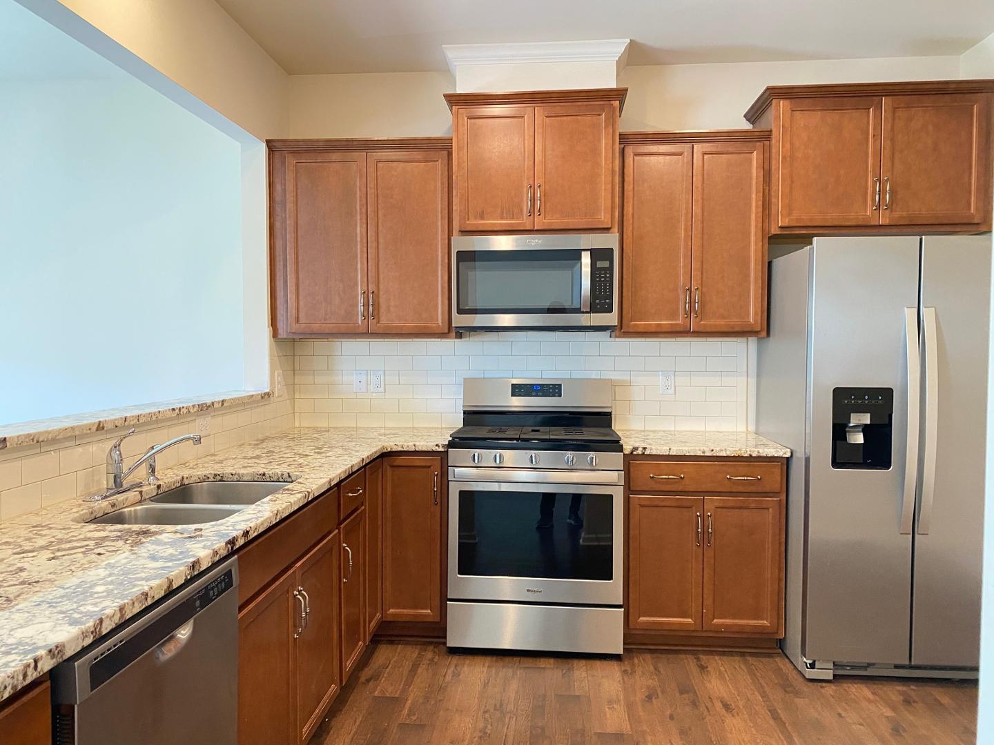 1005 Saffron Loop Durham, NC 27713 - Photo 7 of 26 a kitchen with a sink stove and microwave