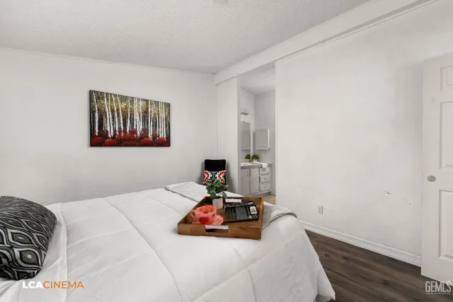 a bedroom with a bed and wall painting