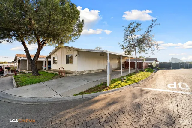 a view of a house with a yard and garage