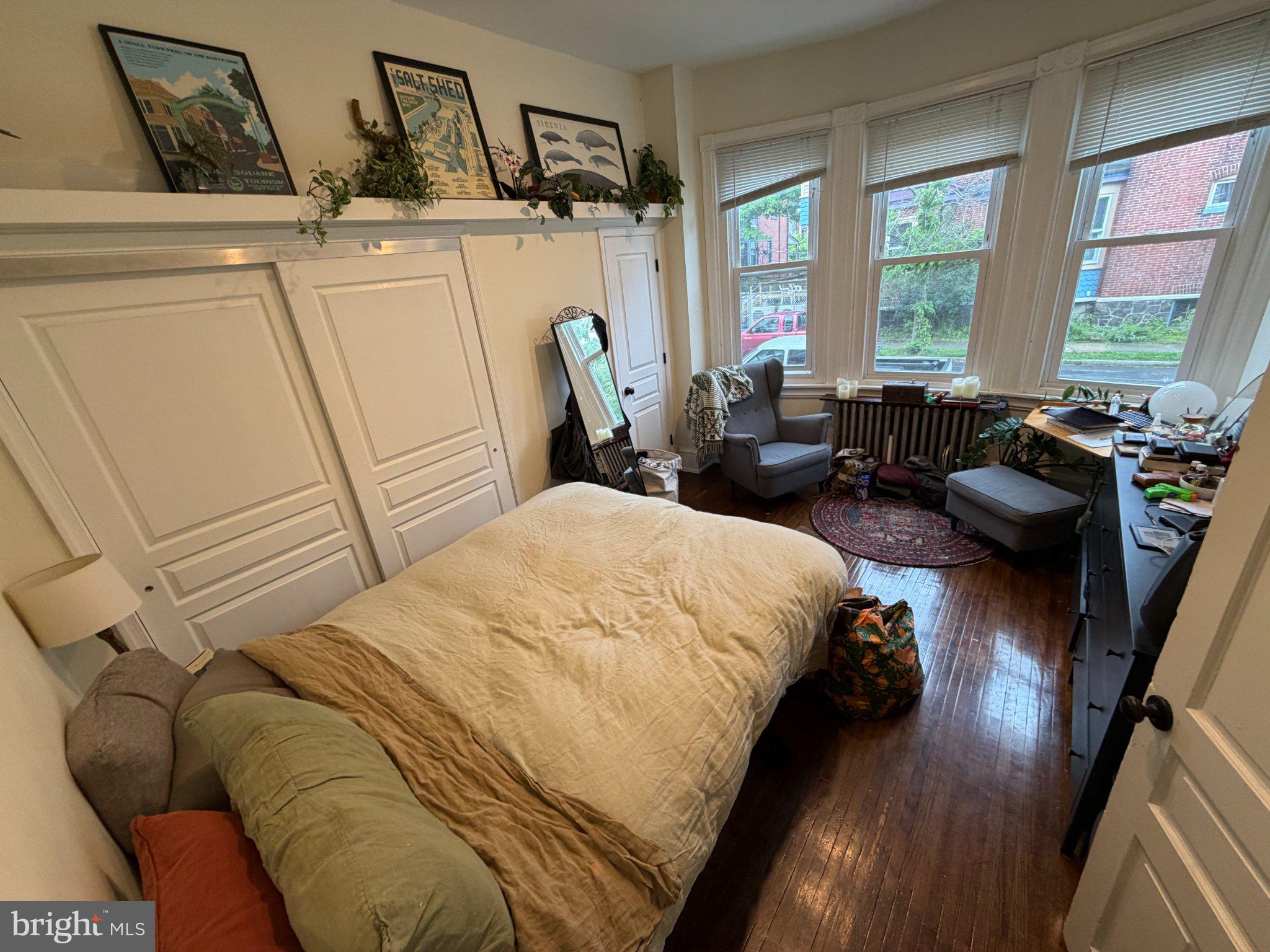 815 South 49th Street Philadelphia, PA 19143 - Photo 14 of 72 a bed sitting in a bedroom next to a window
