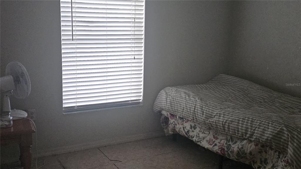 871 Reflections Loop East Winter Haven, FL 33884 - Photo 6 of 23 a bed sitting in a bedroom next to a window