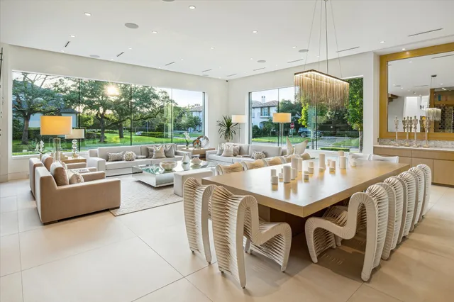 a dining room with furniture and a large window