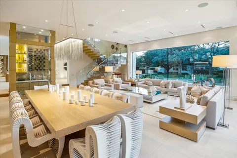 a dining room with furniture a large window and kitchen view