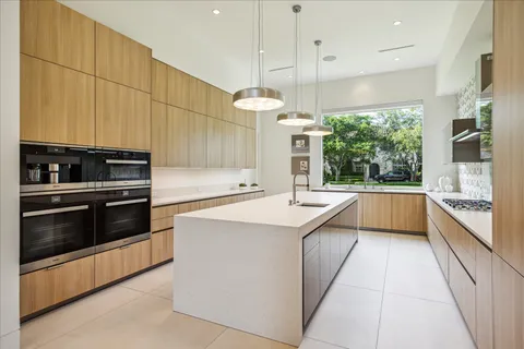 a kitchen with stainless steel appliances a stove a sink and a refrigerator