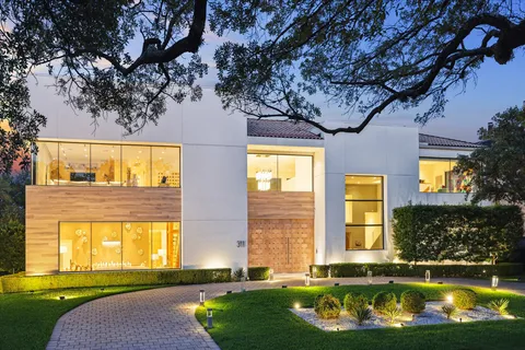 a house with swimming pool in front of it