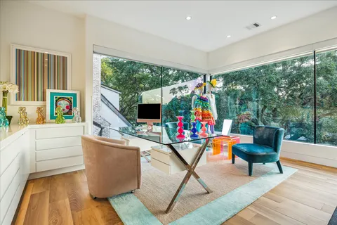 a living room with furniture and floor to ceiling windows