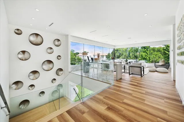 a living room with kitchen island furniture and wooden floor
