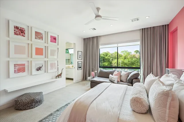 a bedroom with a bed and a large window