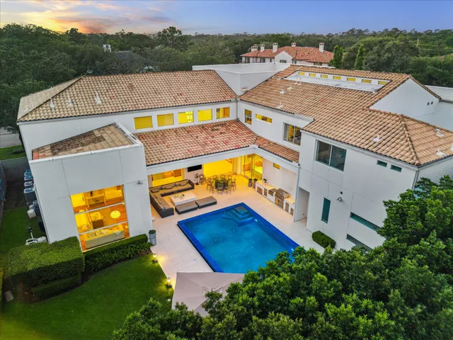 an aerial view of a house with a swimming pool