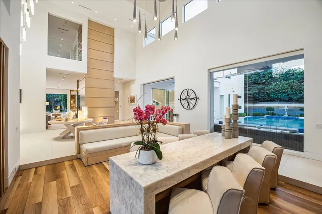 a view of a dining room with furniture a chandelier and wooden floor
