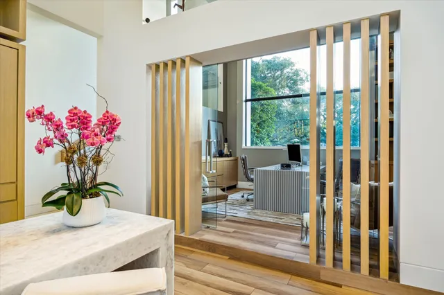 a dining room with furniture and flowers