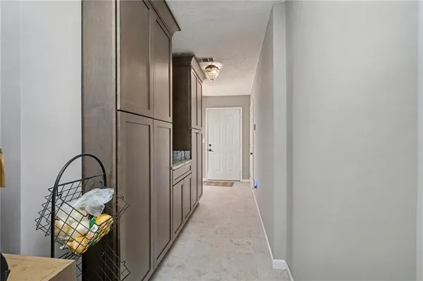 a view of a hallway to a livingroom with furniture