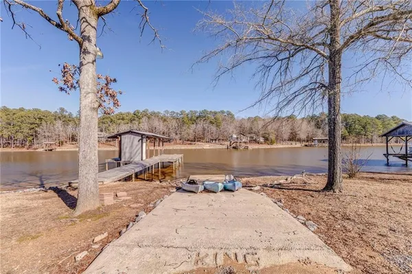 a view of a lake with a table and chairs