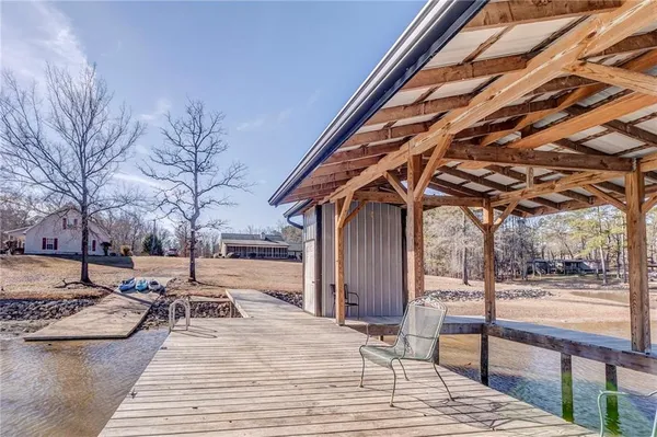 a patio with table and chairs and potted plants