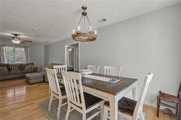a view of a dining room with furniture wooden floor and chandelier