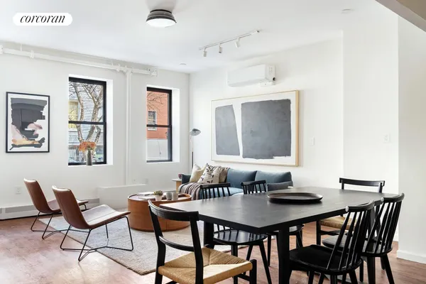 a view of a dining room with furniture and wooden floor