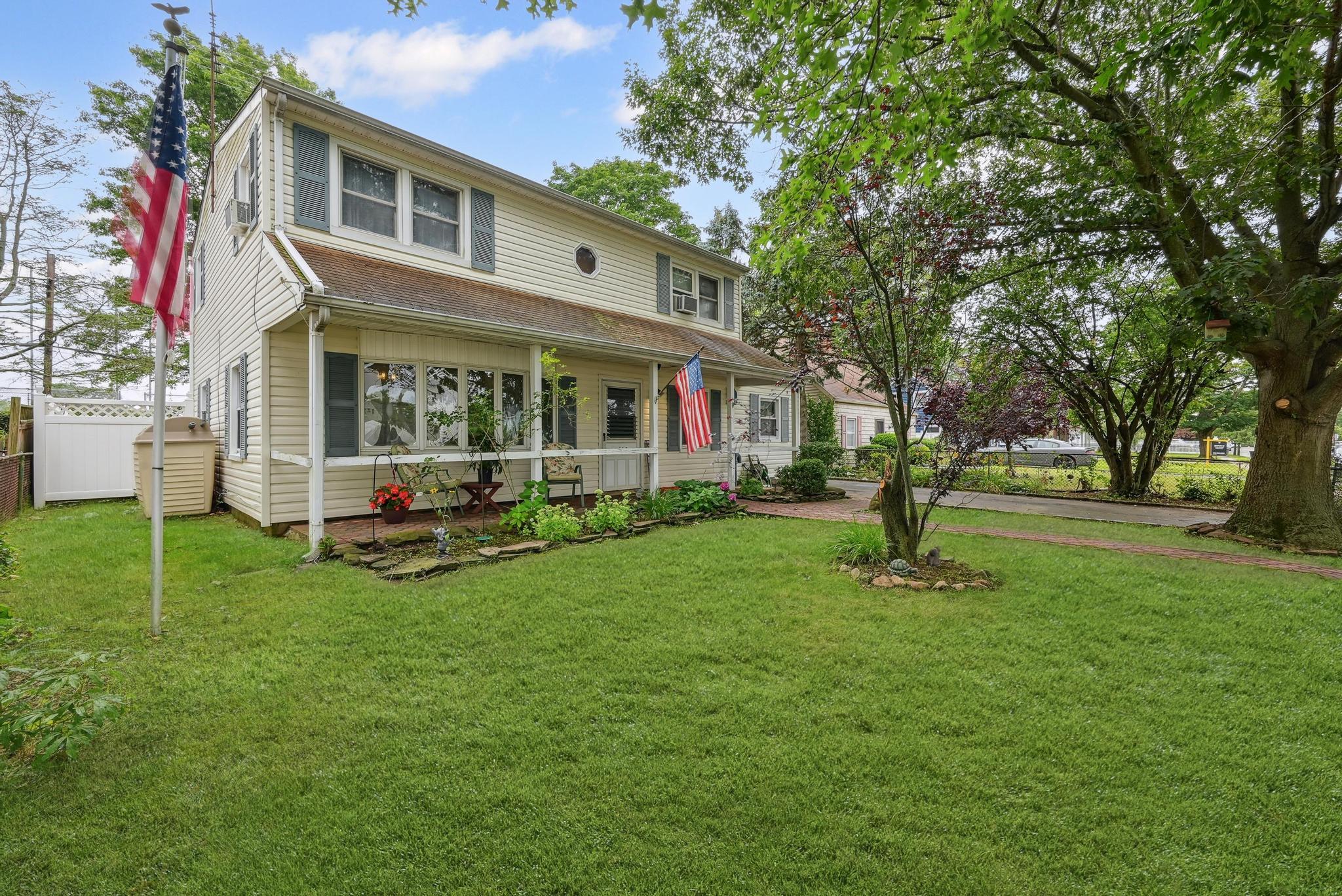 a view of a house with a yard and tree