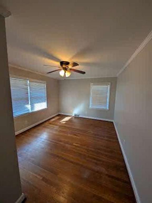 1216 Beech Haven Road Northeast Atlanta, GA 30324 - Photo 12 of 18 an empty room with wooden floor chandelier fan and windows