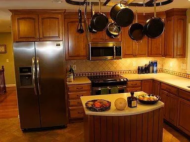 a kitchen with a refrigerator and a stove