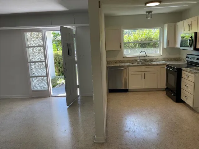 a kitchen with a sink and a large window
