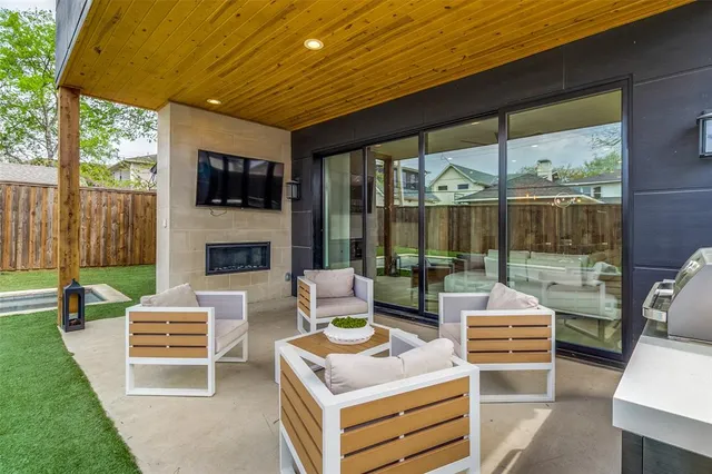 a outdoor space with patio the couches and a fireplace