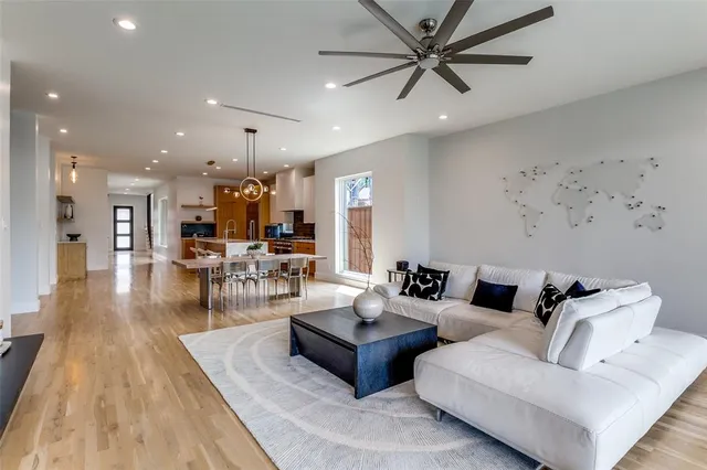 a living room with furniture and a wooden floor