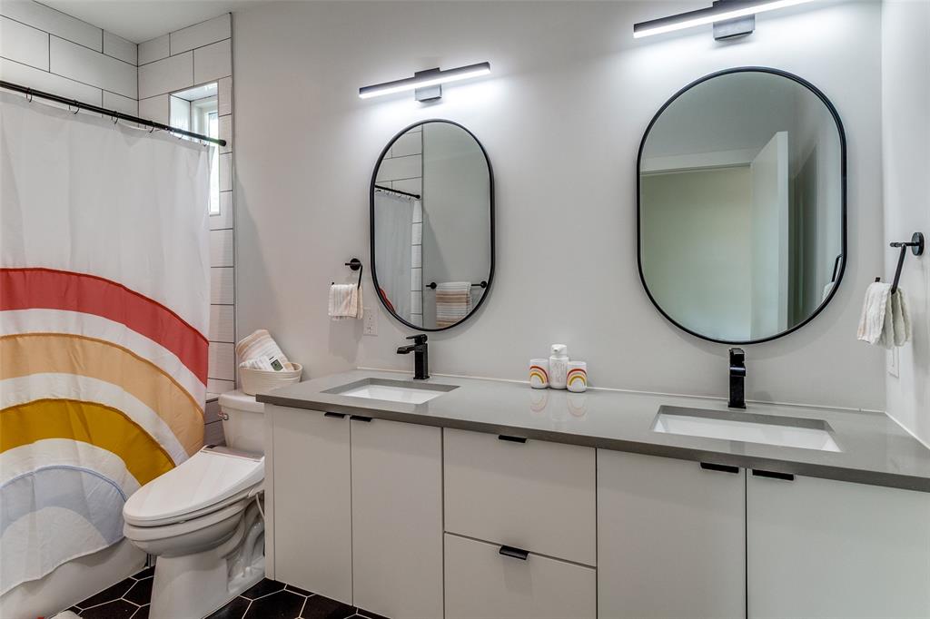6215 Llano Avenue Dallas, TX 75214 - Photo 21 of 38 a bathroom with a sink and a mirror