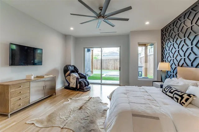 a bedroom with furniture and a flat screen tv