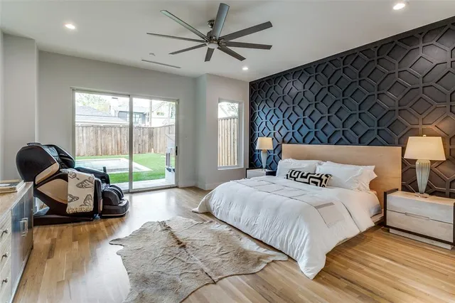 a bedroom with a bed and a large window