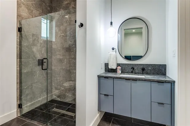 a bathroom with a sink mirror and shower