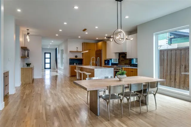 a large kitchen with a table and chairs