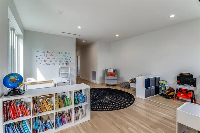 a room with furniture a rug and a book shelf