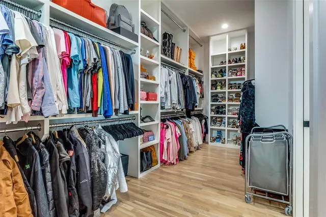 a view of walk in closet with clothes